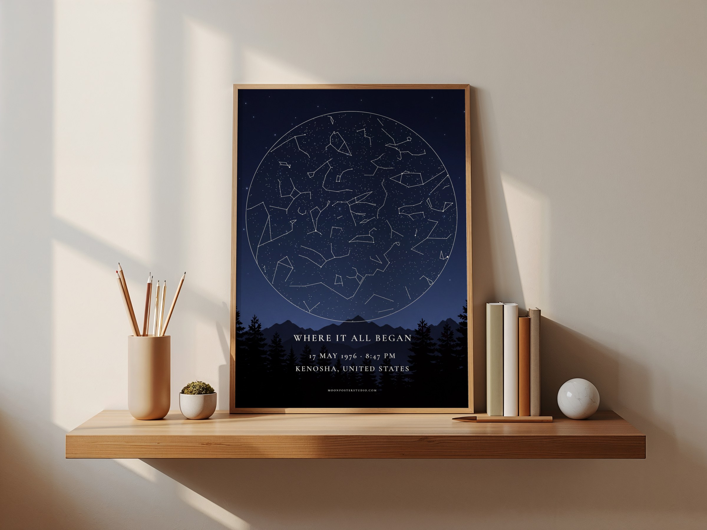 Custom star map 'Where it all began', dark blue sky over a forest, in a wooden frame on a sunlit shelf